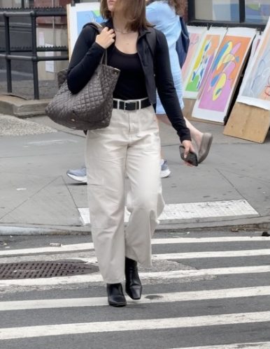 black tank paired with cream fitted jeans