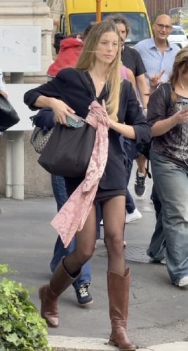 fitted black blazer over a snug black midi skirt