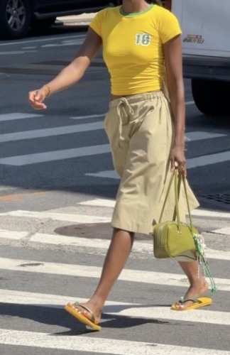 green detailed shirt with tan long shorts