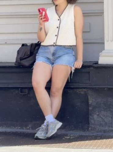 denim shorts and a practical shoulder bag