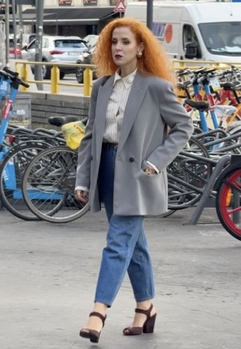  Paired with a grey oversized blazer, a striped button-down, and blue jeans