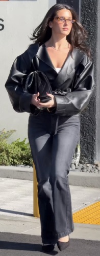 belted leather blazer paired with black-washed bootcut jeans